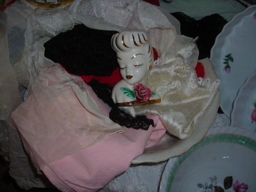 old bowl filled with vintage linens, scarves and my beautiful lady figurine